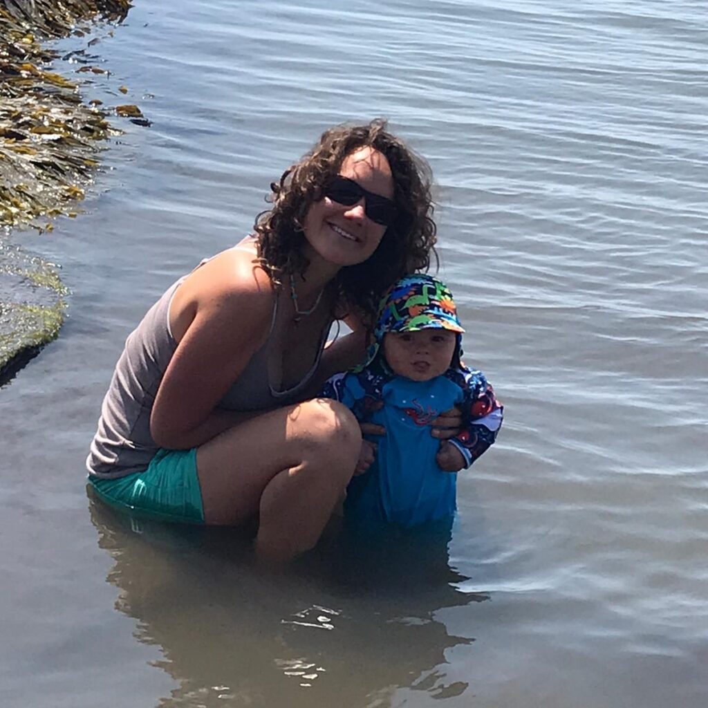 Mother and son in the sea illustrating story on working after having a baby