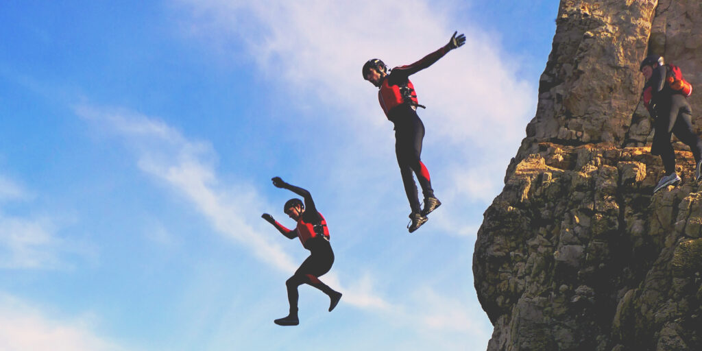 Coasteering activity with people jumping off a cliff, found on Tripadvisor