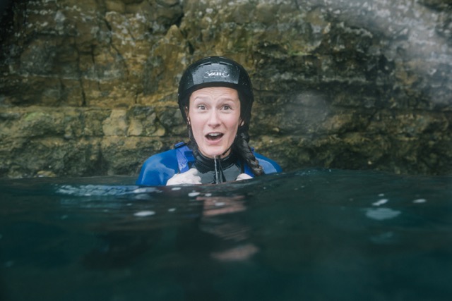 woman coasteering in the water