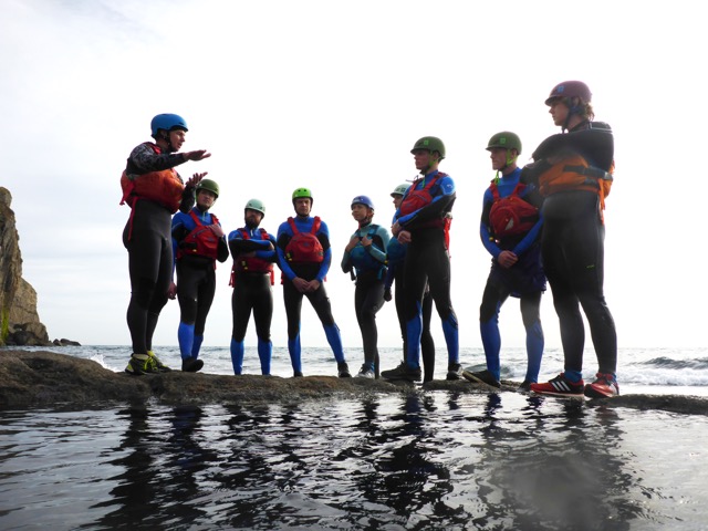 outdoor instructors gathering on the rocks near Swanage