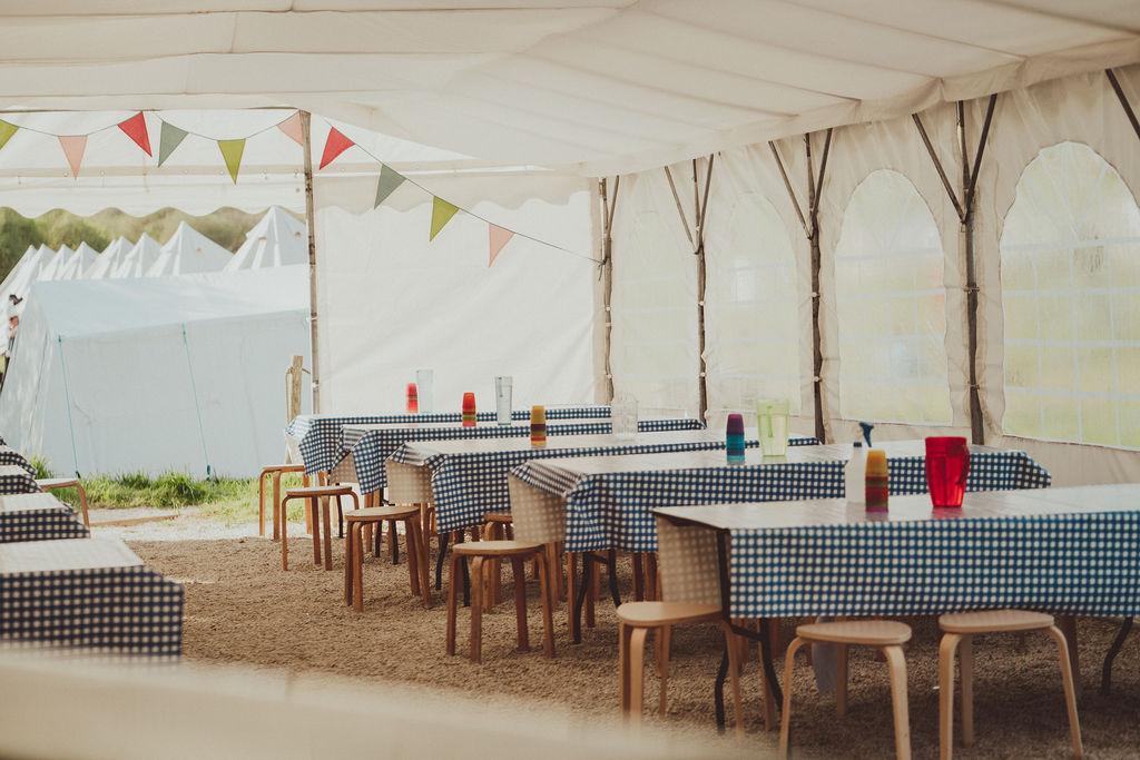 Tables set out in a tent 